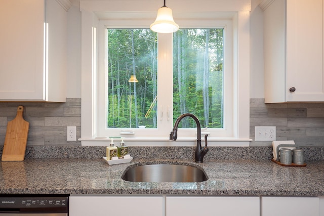 kitchen with white cabinetry, light stone counters, dishwasher, and sink