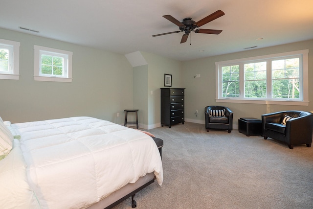 carpeted bedroom with ceiling fan and multiple windows