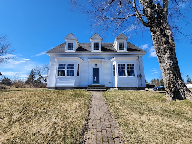 cape cod home with a front lawn