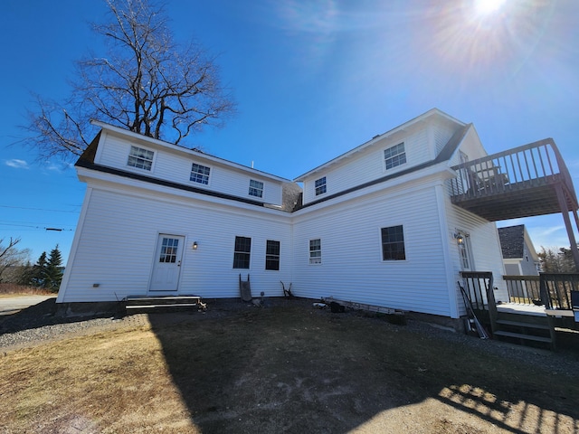 rear view of property featuring a deck