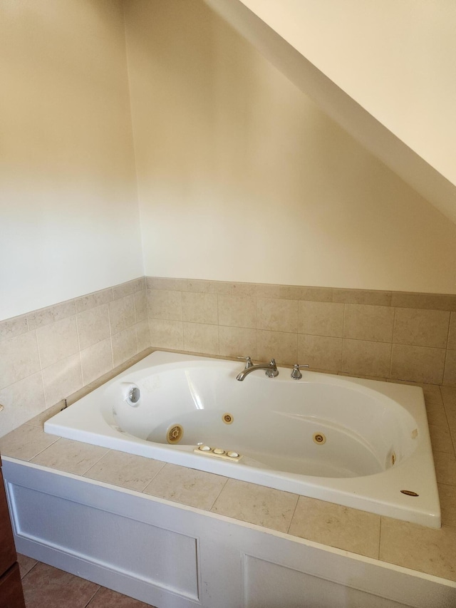 bathroom featuring tile patterned flooring and a relaxing tiled tub