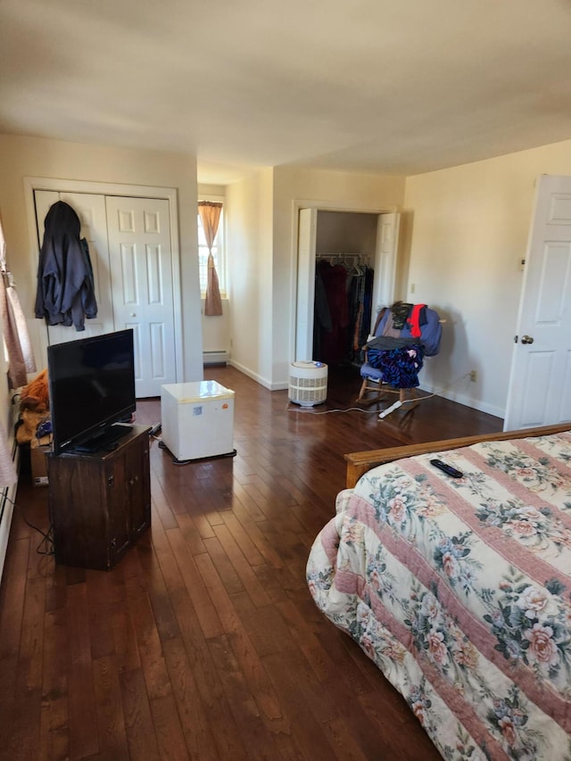 bedroom with dark hardwood / wood-style flooring and a baseboard radiator