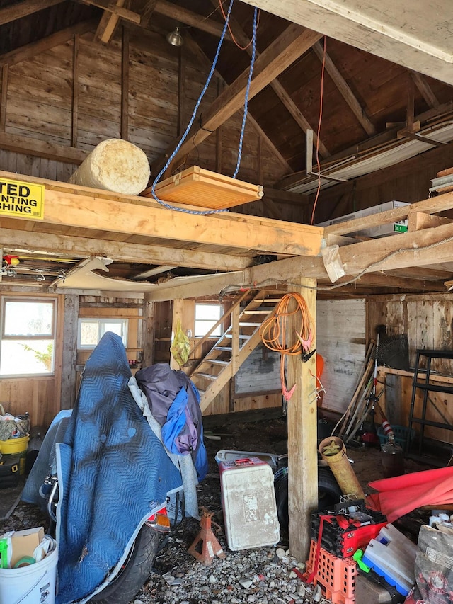 interior space featuring wood walls and lofted ceiling