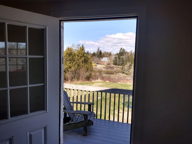 doorway to outside with wood-type flooring