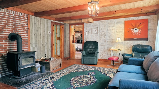 living room featuring beamed ceiling, wood-type flooring, a wood stove, and wood ceiling