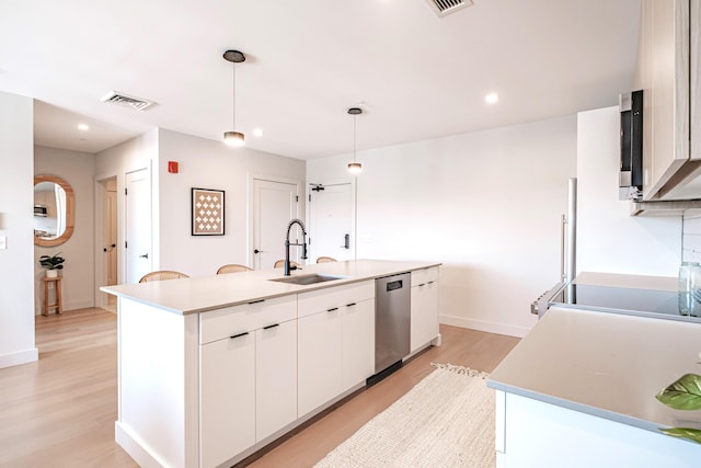 kitchen with dishwasher, a center island with sink, sink, hanging light fixtures, and white cabinetry