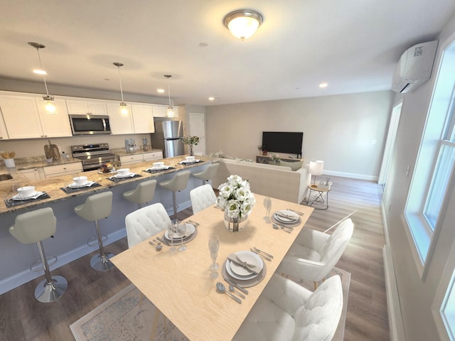 dining room featuring dark hardwood / wood-style flooring and an AC wall unit