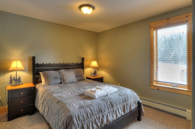 bedroom featuring light carpet and baseboard heating