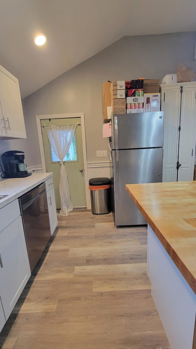 kitchen with white cabinets, lofted ceiling, and appliances with stainless steel finishes