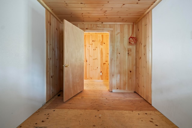 interior space featuring light hardwood / wood-style floors, wood walls, and wooden ceiling