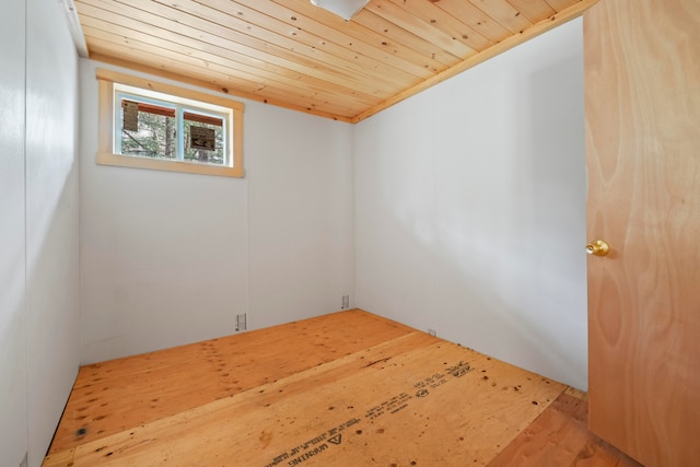 empty room with wooden ceiling and light hardwood / wood-style flooring