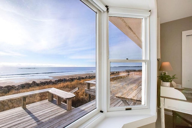 interior space with a water view and a view of the beach