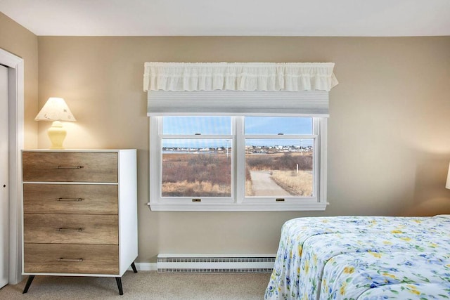 bedroom featuring carpet and a baseboard heating unit