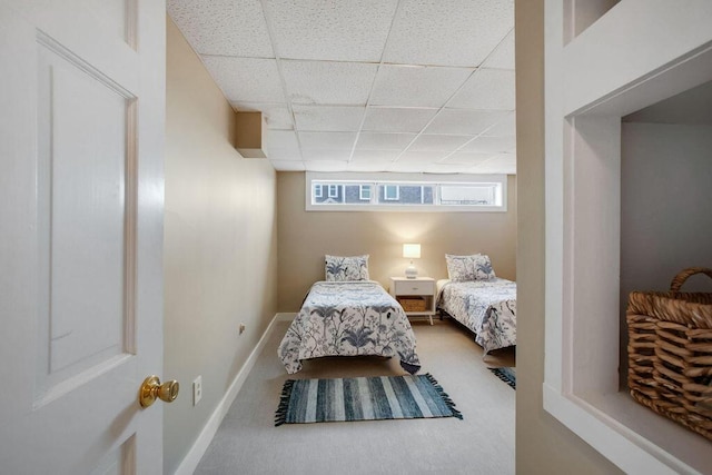 carpeted bedroom featuring a paneled ceiling