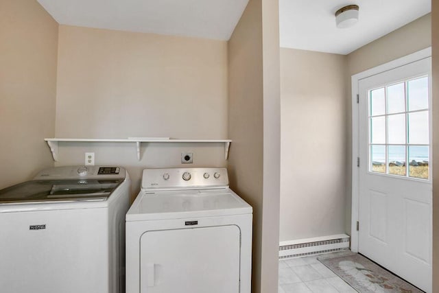 clothes washing area featuring washing machine and dryer, light tile patterned floors, and a baseboard radiator