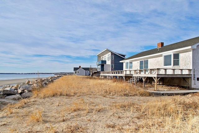 view of yard with a deck with water view