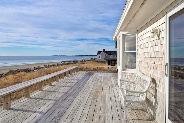 deck with a water view and a beach view