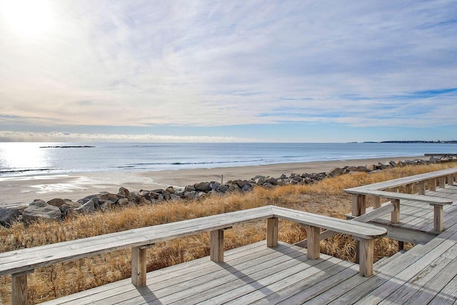 deck with a water view and a beach view