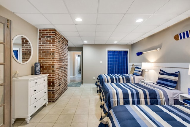 bedroom with light tile patterned floors and a paneled ceiling