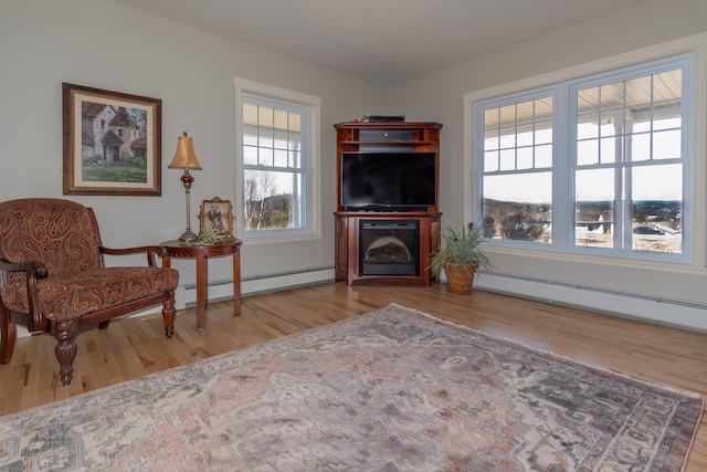 living area with baseboard heating and light wood-type flooring