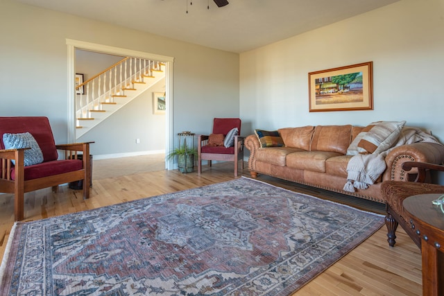 living room with light hardwood / wood-style floors and ceiling fan