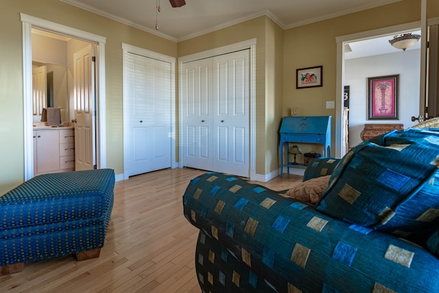 bedroom featuring ceiling fan, ornamental molding, connected bathroom, and light hardwood / wood-style flooring