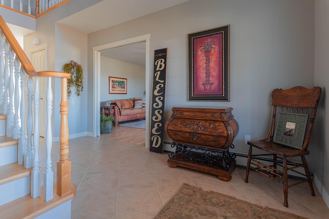 living area featuring baseboard heating and light tile patterned flooring