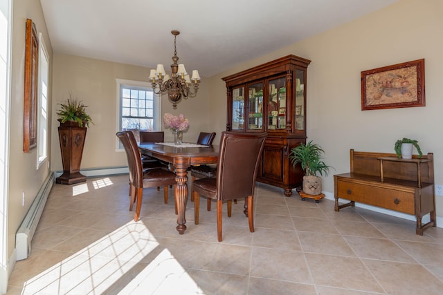 tiled dining area with a baseboard heating unit and a chandelier