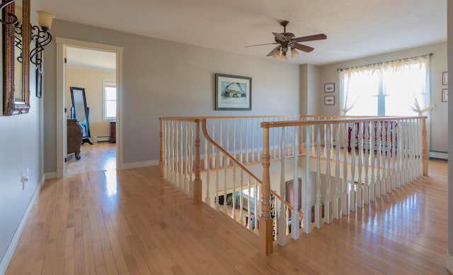 hallway featuring light hardwood / wood-style floors and a baseboard heating unit