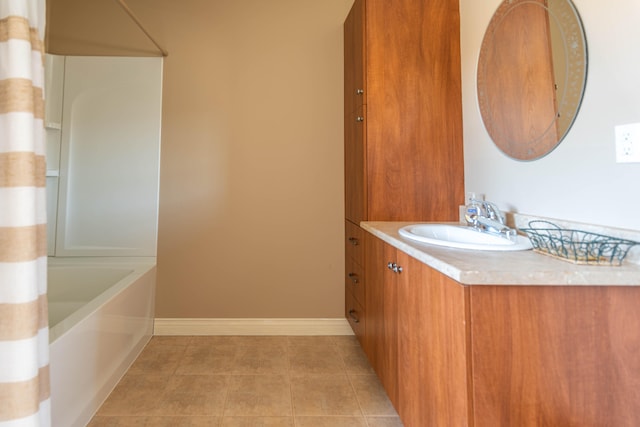 bathroom featuring washtub / shower combination, tile patterned floors, and vanity