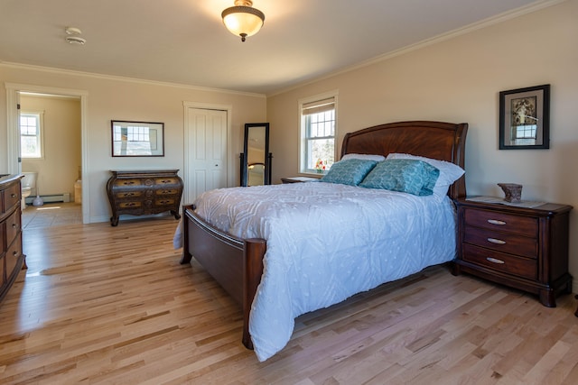 bedroom with a baseboard heating unit, a closet, crown molding, and light hardwood / wood-style flooring