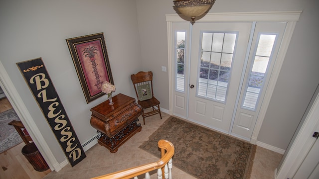 foyer featuring baseboard heating and light tile patterned floors