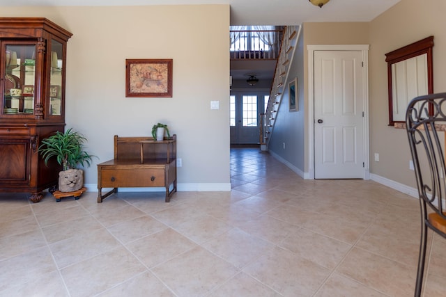 foyer with light tile patterned floors and french doors