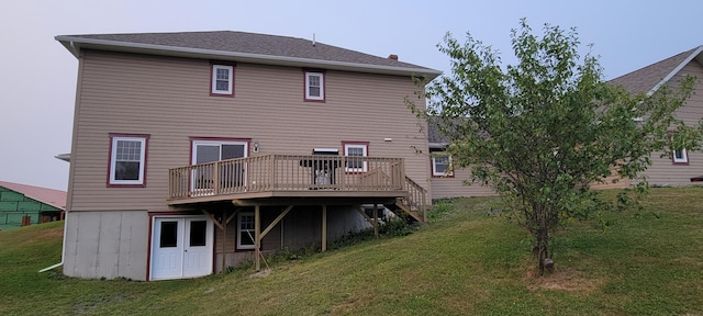 back of house featuring a deck and a yard