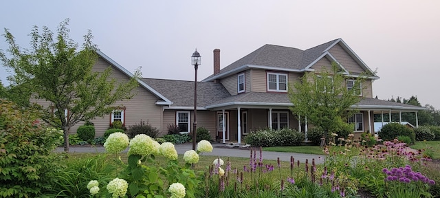 149 Bellevue St, Madawaska, ME 04756 - view of front of house with covered porch, roof with shingles, and a chimney