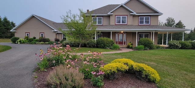 view of front of house featuring a porch and a front yard