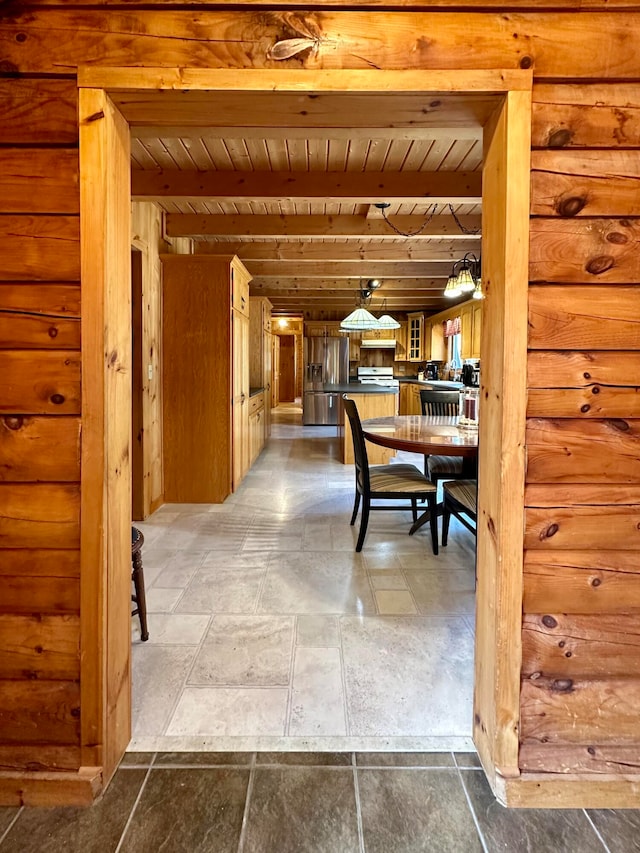 dining space with beam ceiling and wooden ceiling