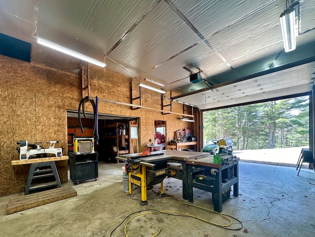 garage with a workshop area and a garage door opener