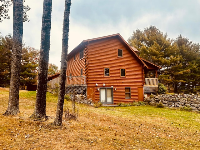 view of home's exterior featuring a lawn and a deck