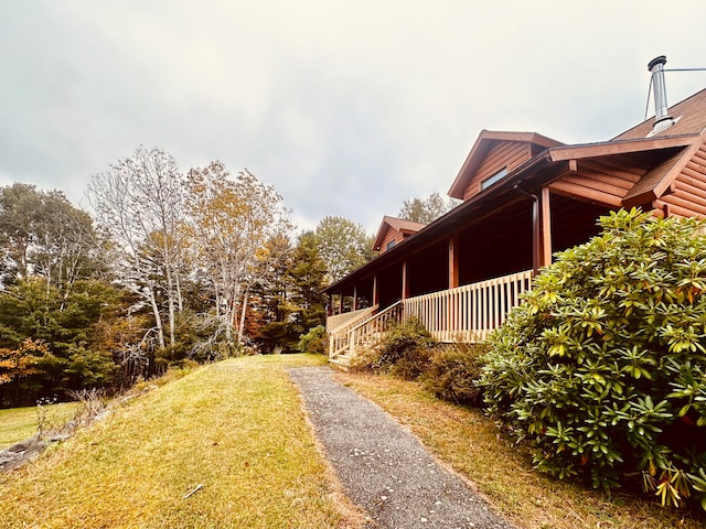 view of side of home with a yard