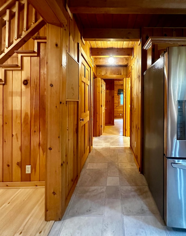 corridor featuring wood walls, wood ceiling, and beam ceiling