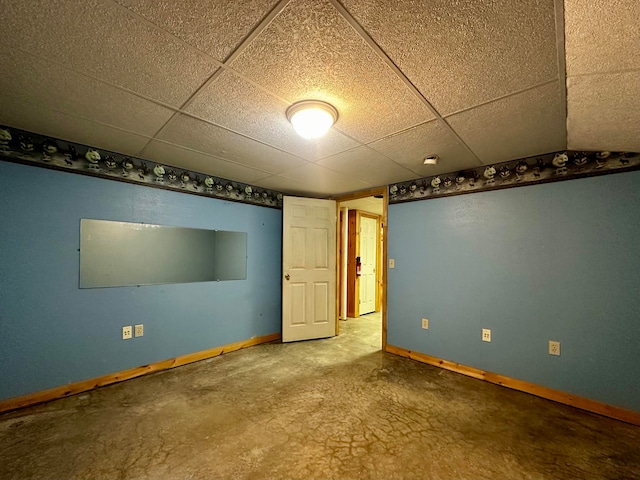 basement with a paneled ceiling