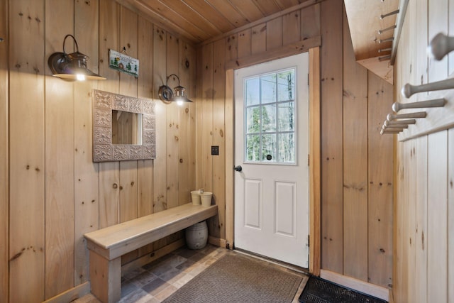 mudroom featuring wood walls and tile flooring