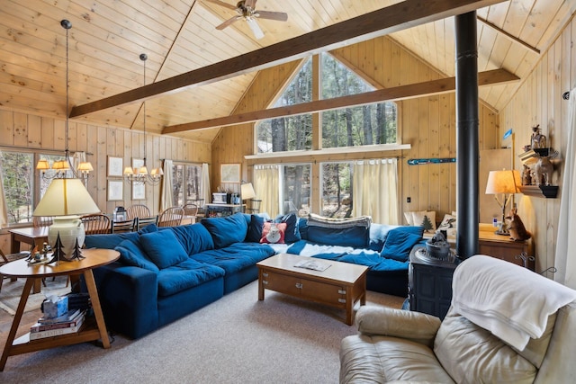 living room with beamed ceiling, plenty of natural light, and wooden walls