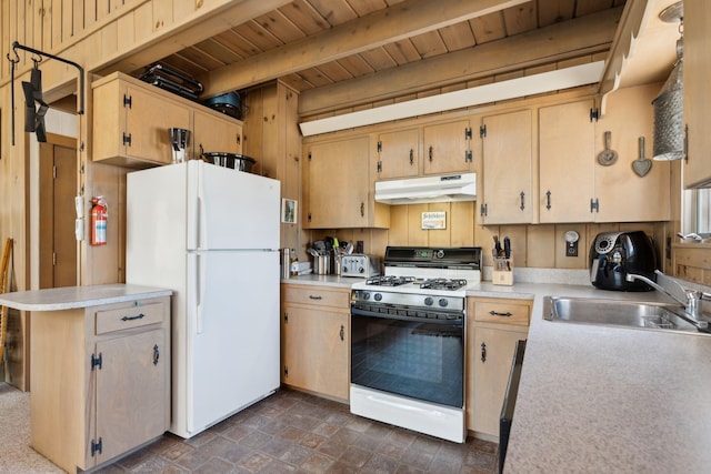 kitchen with white appliances, dark tile flooring, beam ceiling, wooden ceiling, and sink