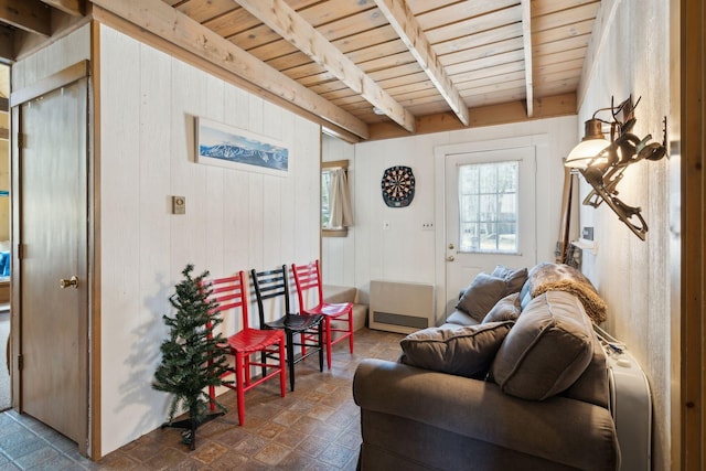 living room with dark tile floors and beam ceiling