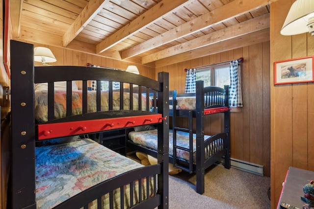 carpeted bedroom with wooden ceiling, beam ceiling, a baseboard radiator, and wooden walls