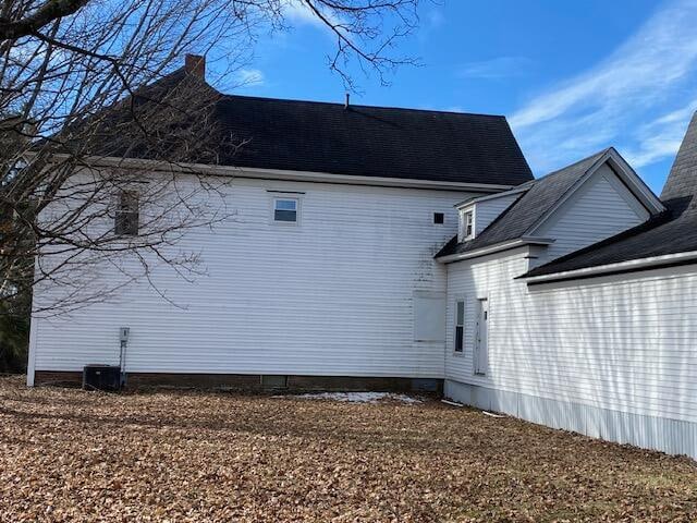 view of side of home with central AC unit