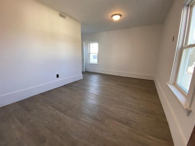 empty room featuring dark hardwood / wood-style flooring