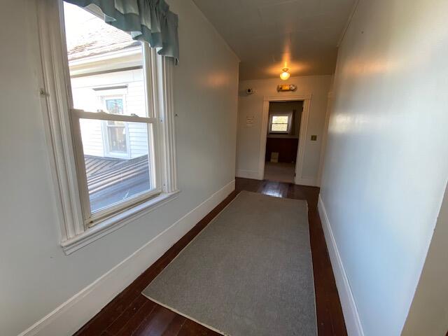 hallway featuring dark wood-type flooring